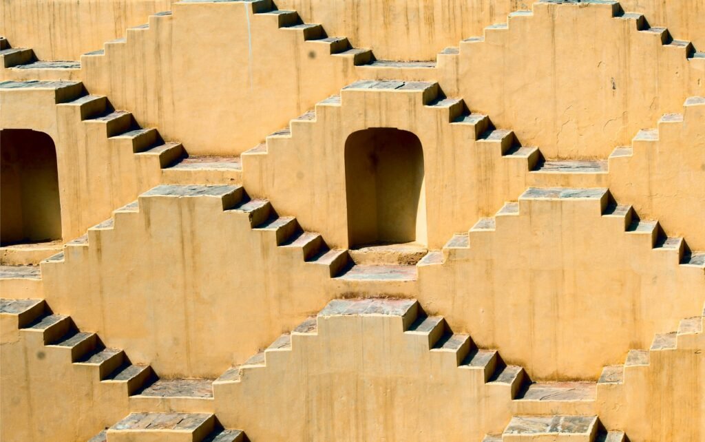 Intricate symmetrical steps of a Jaipur stepwell showcasing ancient architectural design.
