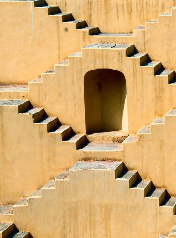 Intricate symmetrical steps of a Jaipur stepwell showcasing ancient architectural design.